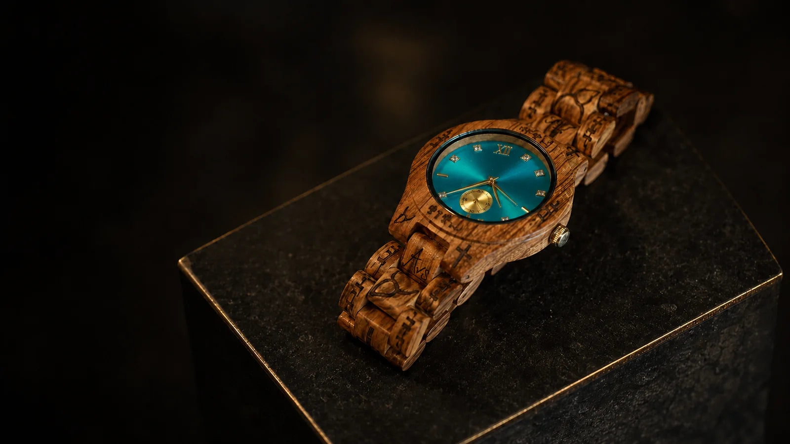 The Aqua Genesis wooden watch, teal dial, on dark stone